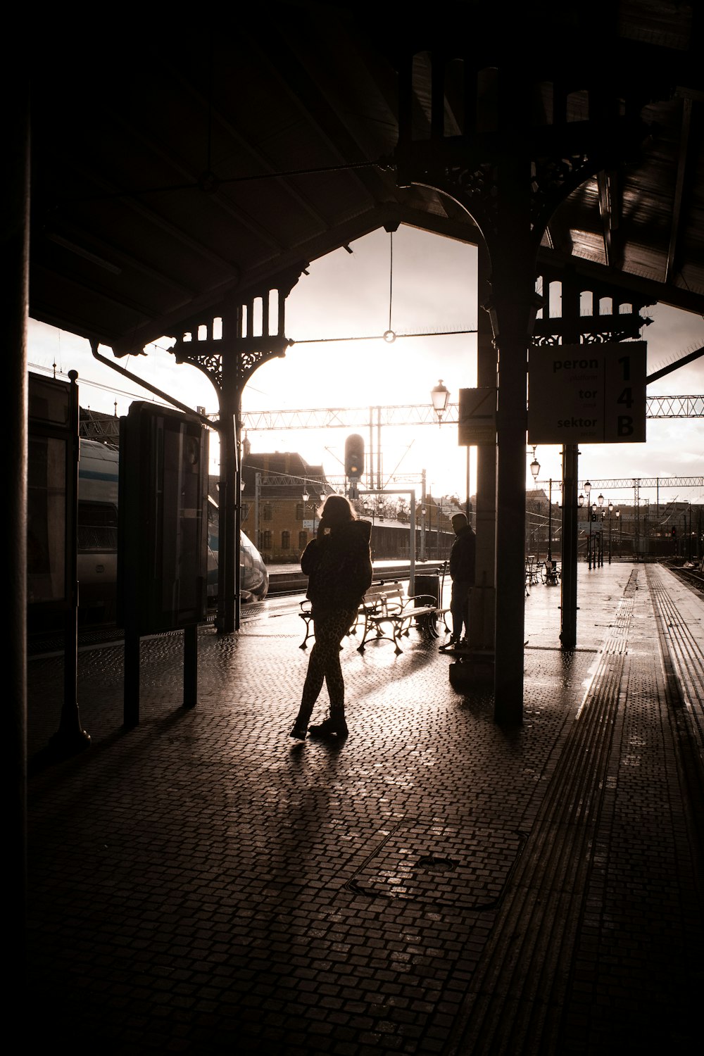 a person with a backpack walking on a train platform
