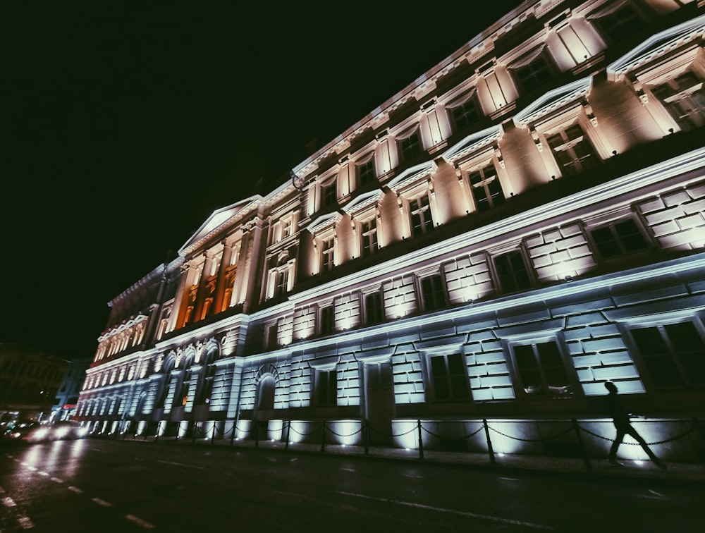 a building lit up at night with lights on it