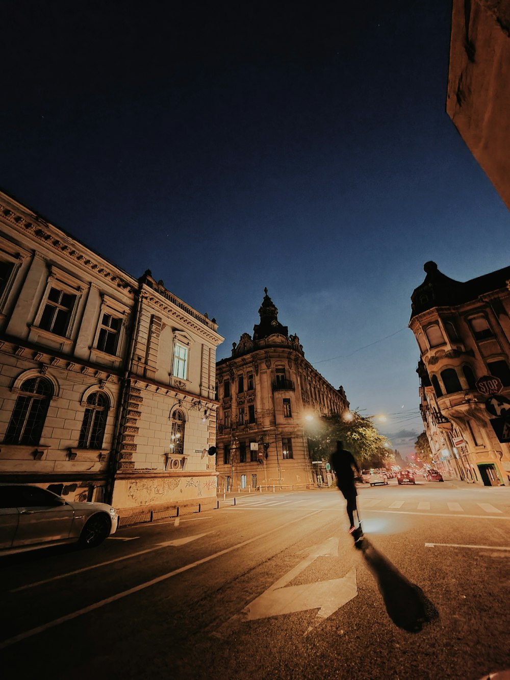 a person walking across a street at night