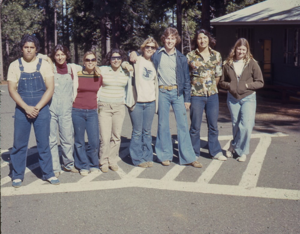 a group of people standing in a parking lot