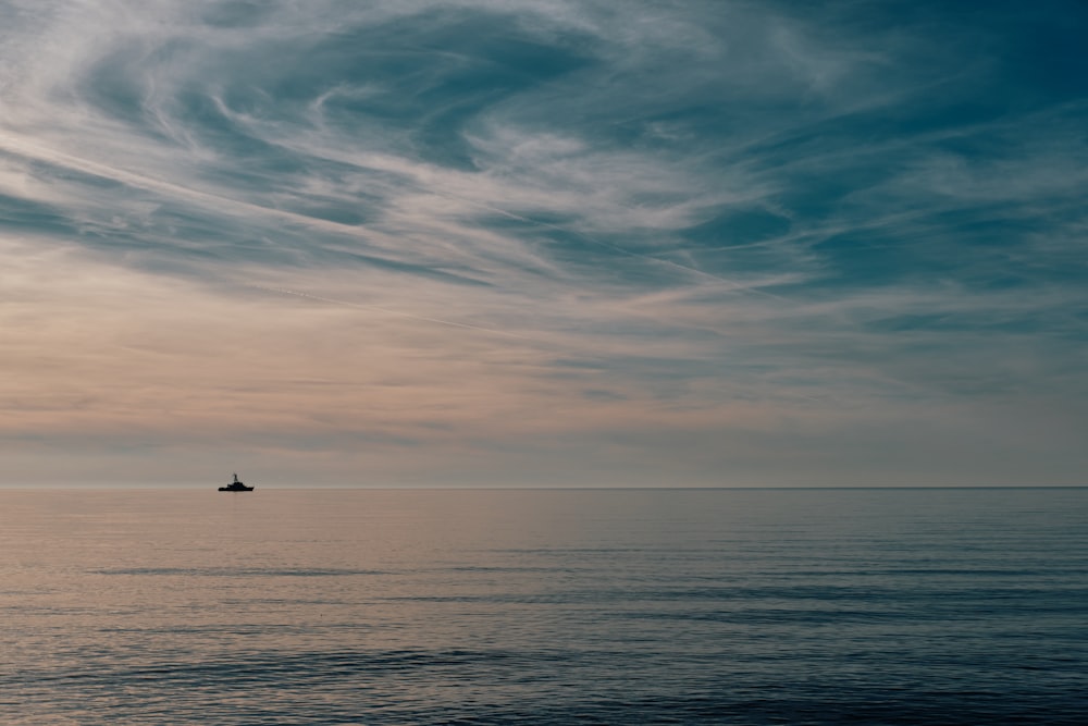 a lone boat in the middle of a large body of water