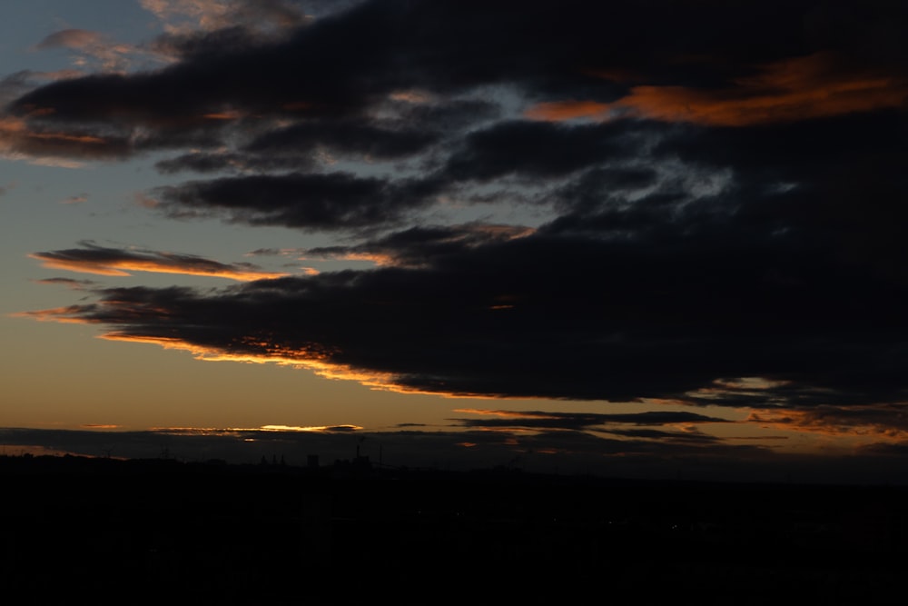 the sun is setting over the horizon of a city