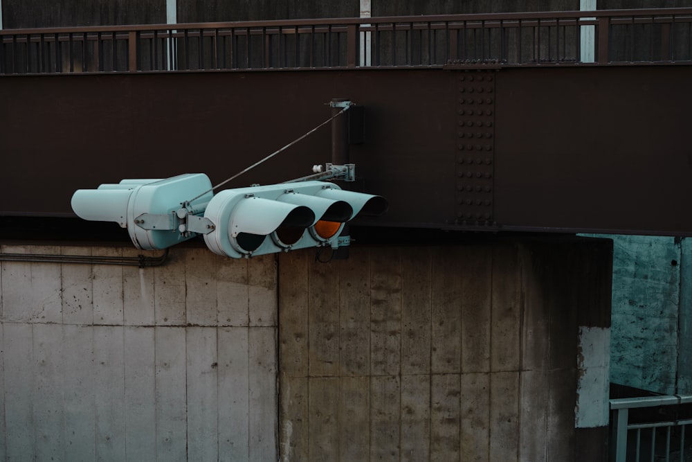 two traffic lights are attached to a wall