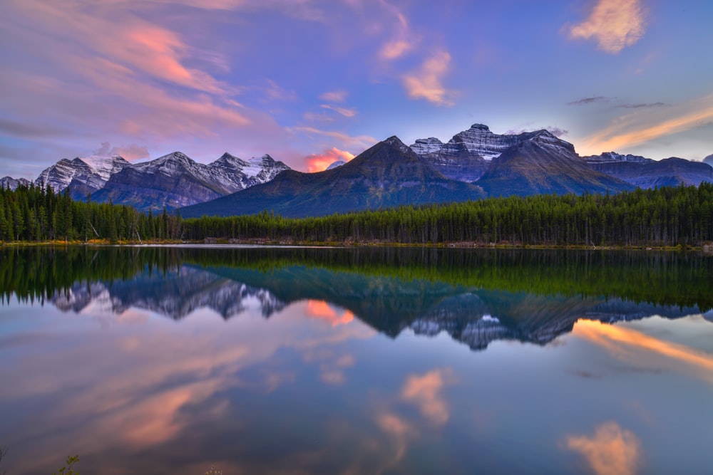 Une chaîne de montagnes se reflète dans l’eau calme d’un lac