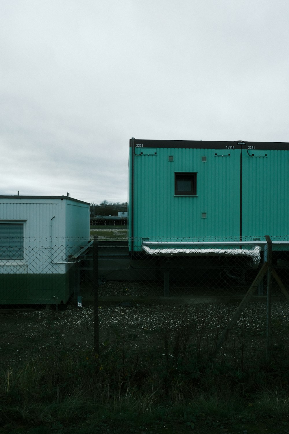 a couple of blue buildings sitting next to each other