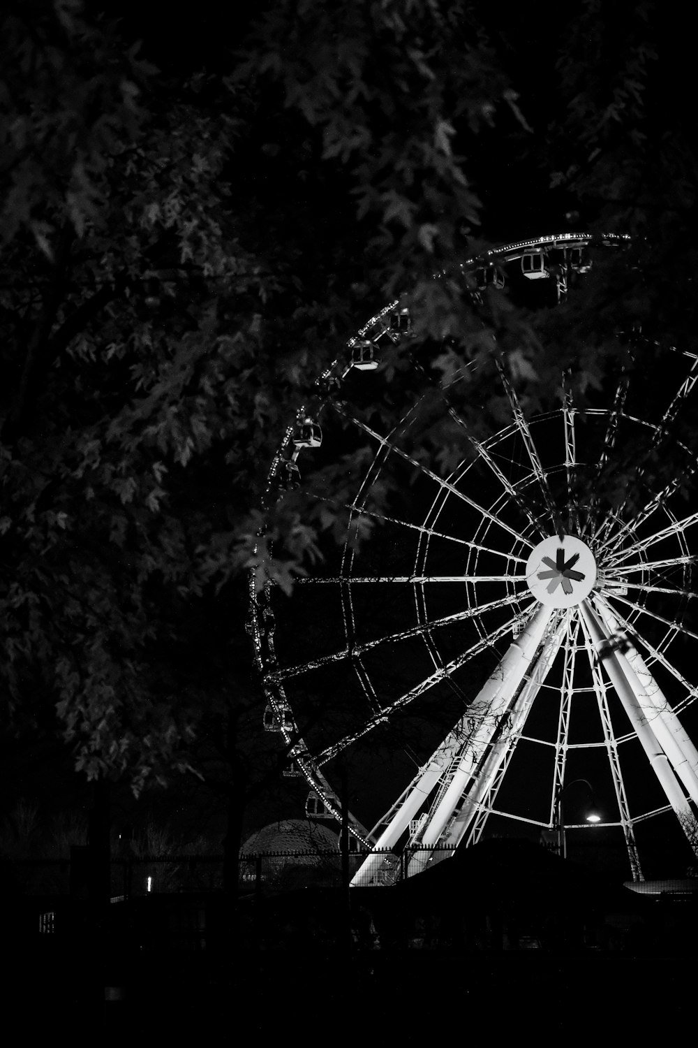 a black and white photo of a ferris wheel