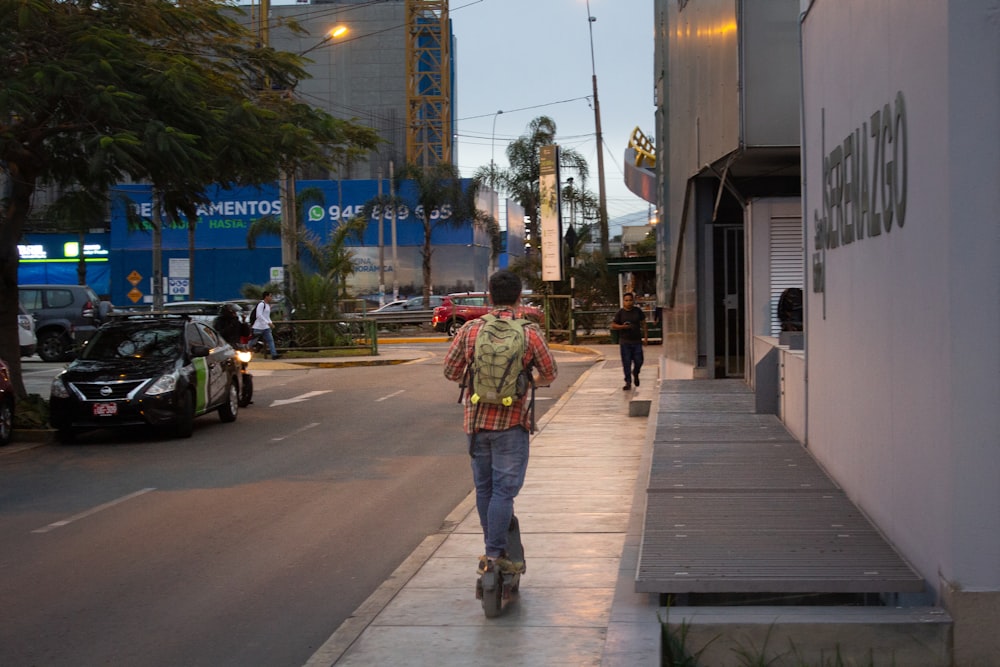 a man riding a skateboard down a sidewalk