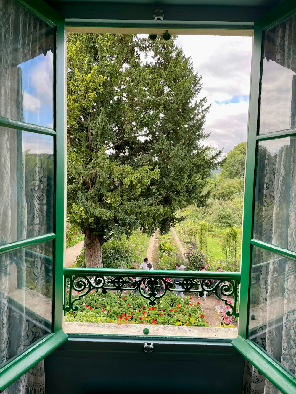 an open window with a view of a garden