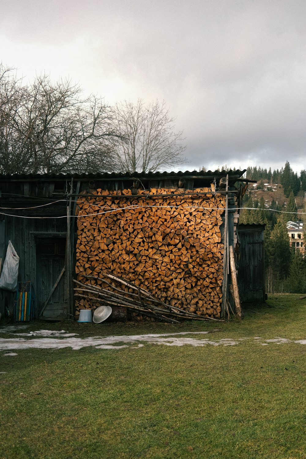 a pile of wood sitting next to a building