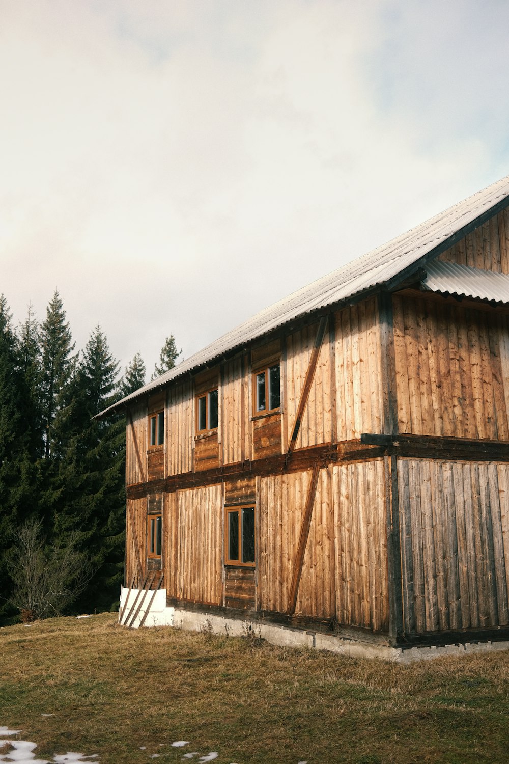 a large wooden building sitting next to a forest