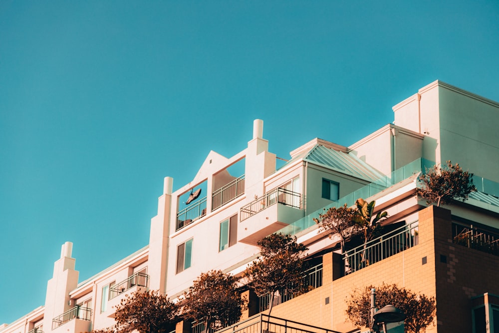 a tall building with balconies on the top of it