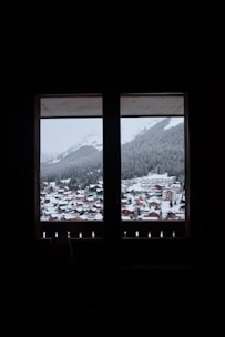 a view out a window of a snowy town