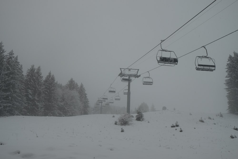 a ski lift going up a snowy mountain