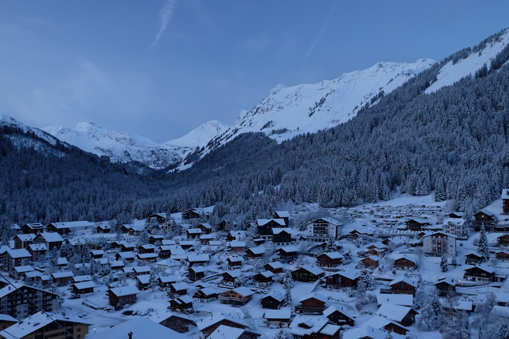 a snowy village in the middle of a mountain range