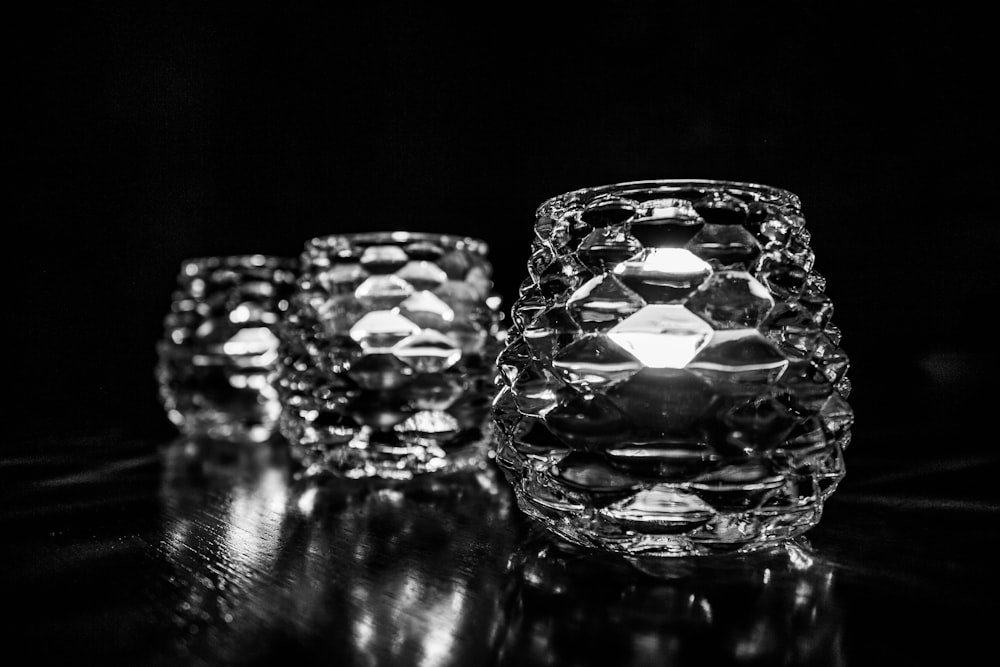 three glass vases sitting on top of a table