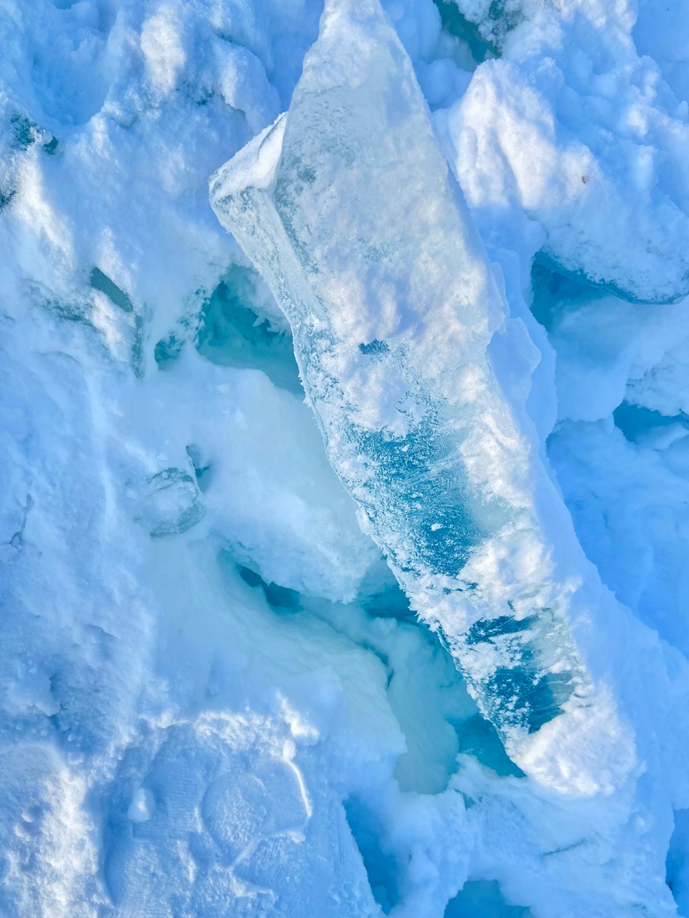 an aerial view of an iceberg in the water