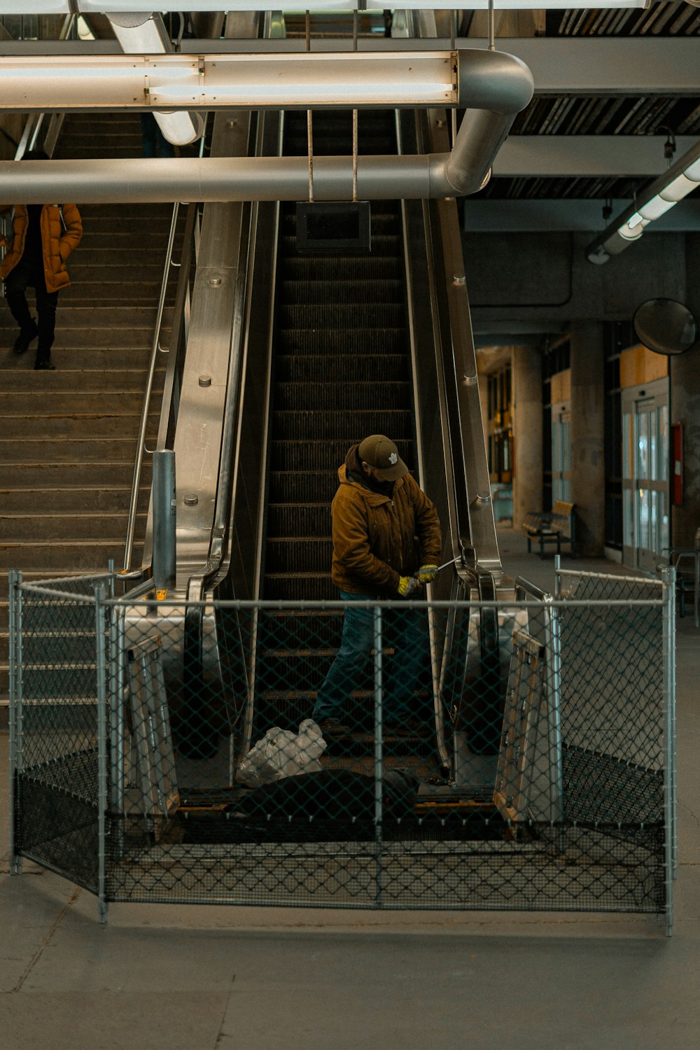 a man sitting on an escalator talking on a cell phone