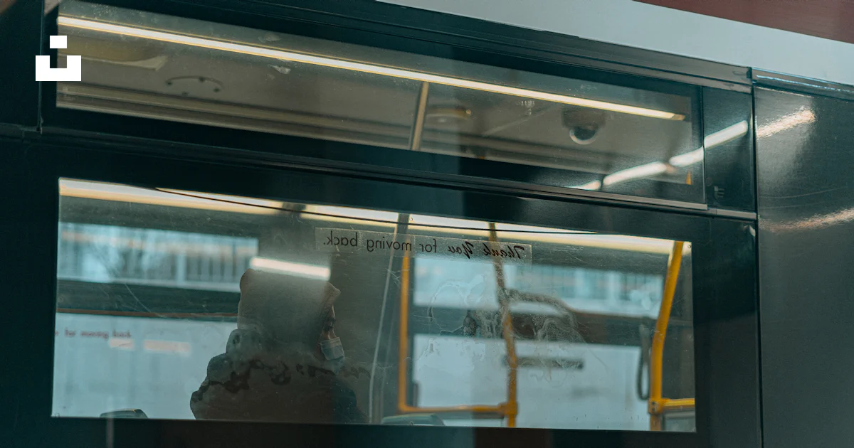 A reflection of a person in a window on a bus photo – Free People Image ...
