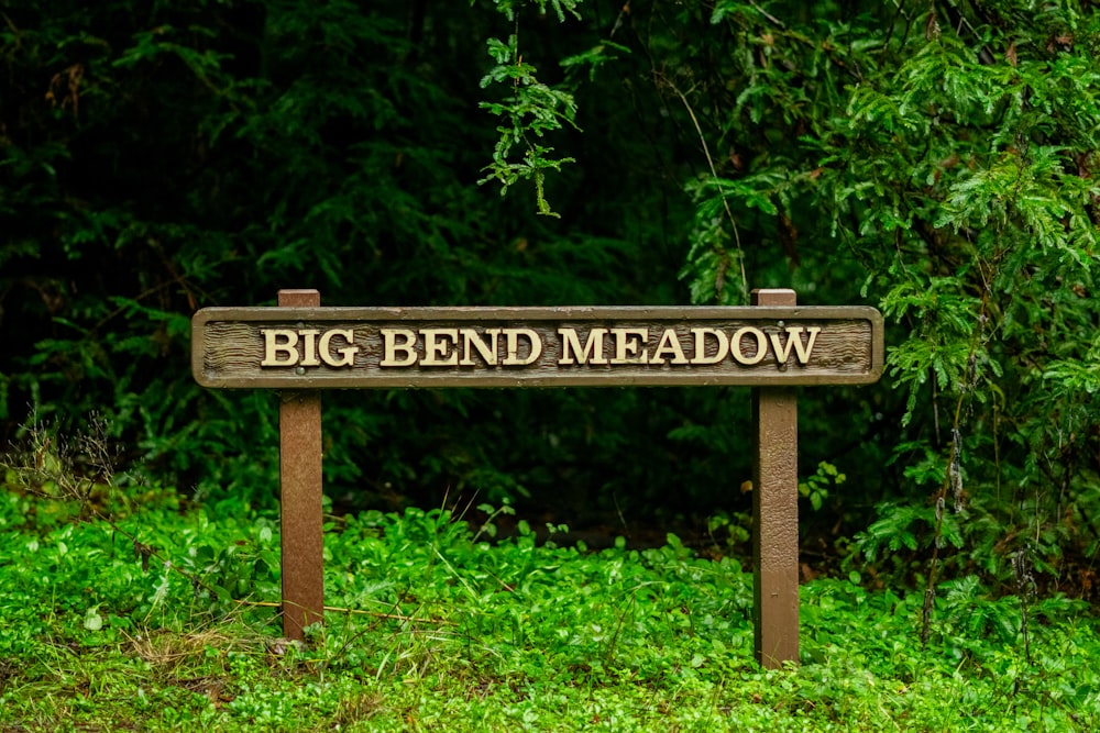 a sign that says big bend meadow in front of some trees