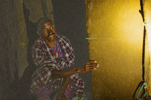 a man sitting on the floor with a skateboard
