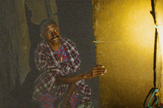 a man sitting on the floor with a skateboard