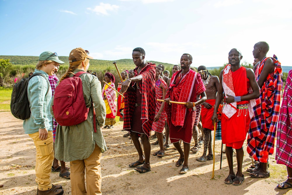 a group of people standing around each other