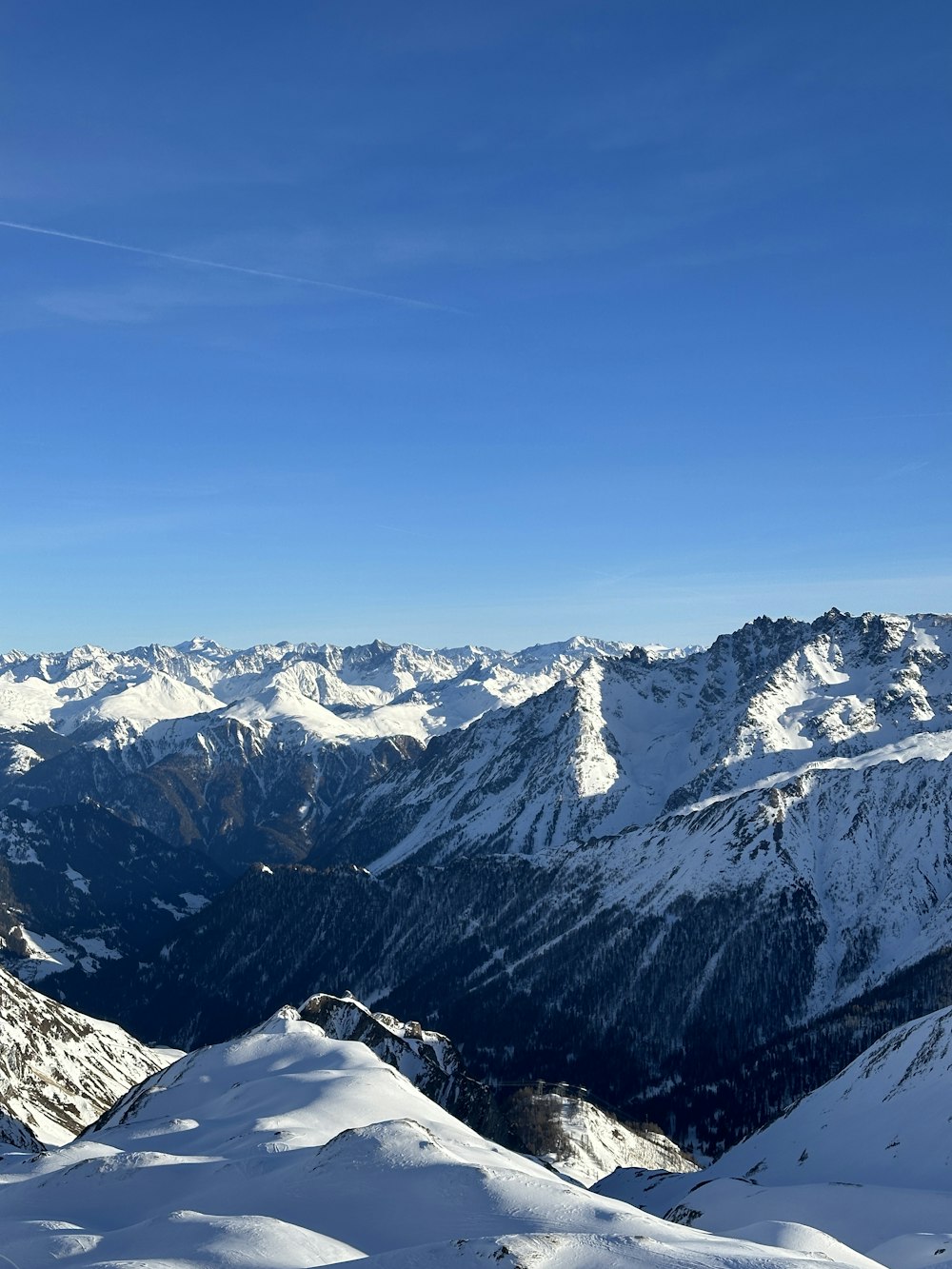 a person standing on top of a snow covered mountain