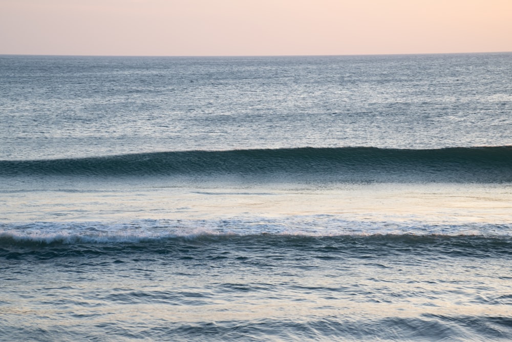 a man riding a wave on top of a surfboard