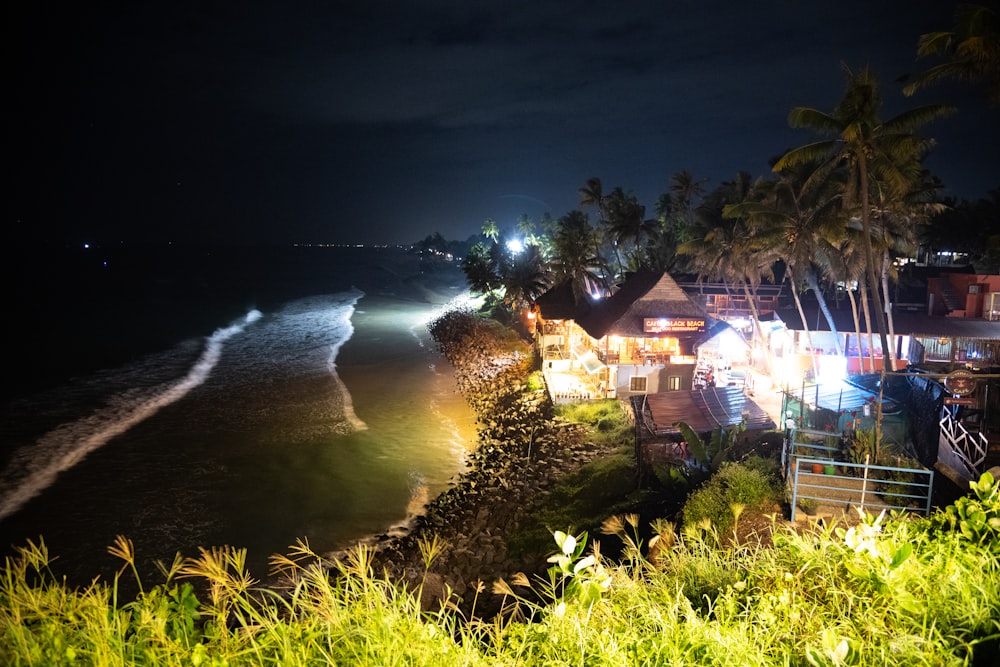 a view of a beach at night with lights on