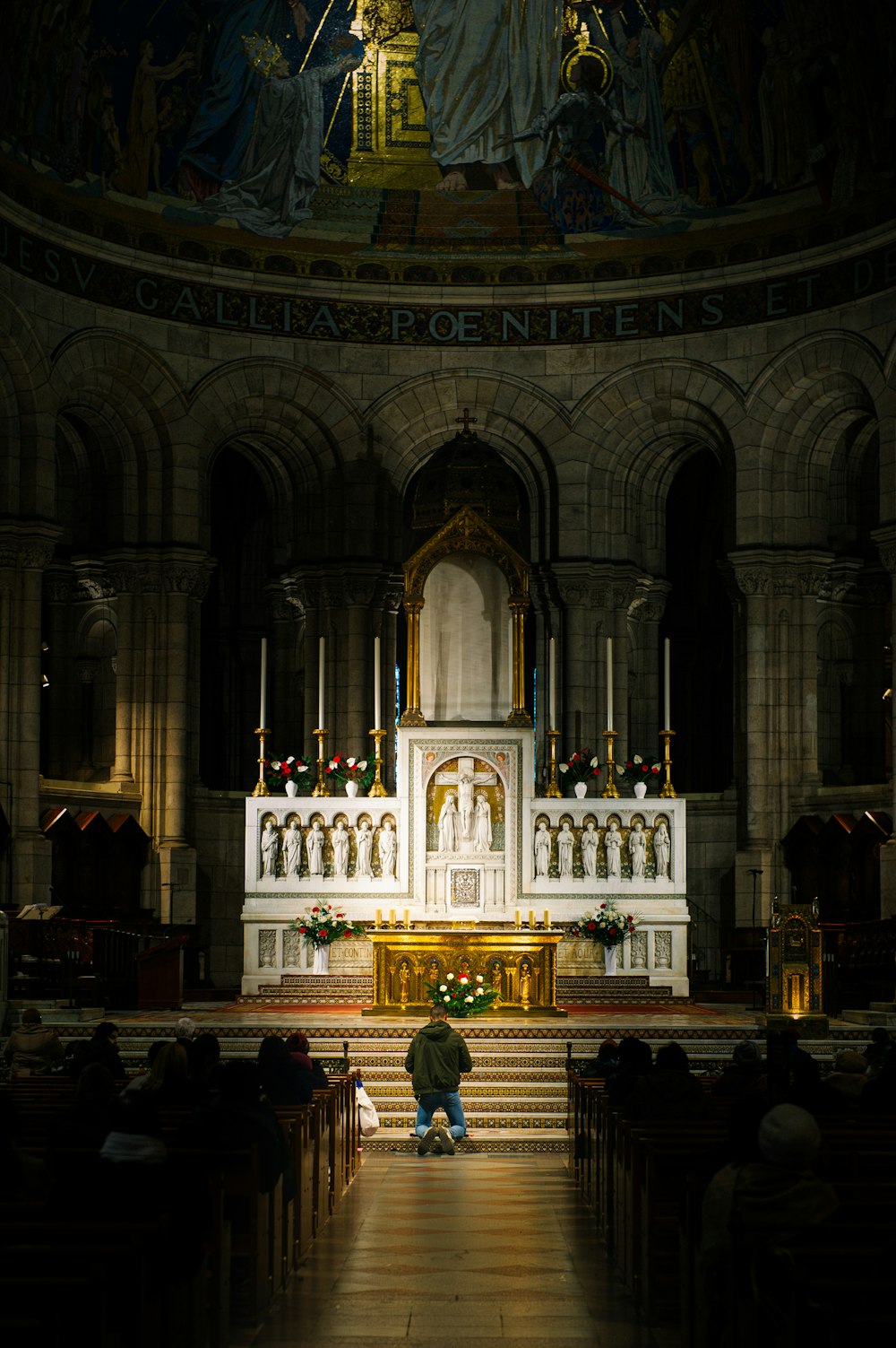 a man kneeling down in front of a church alter