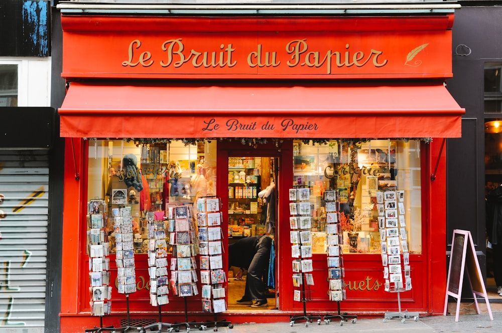 a red store front with a red awning