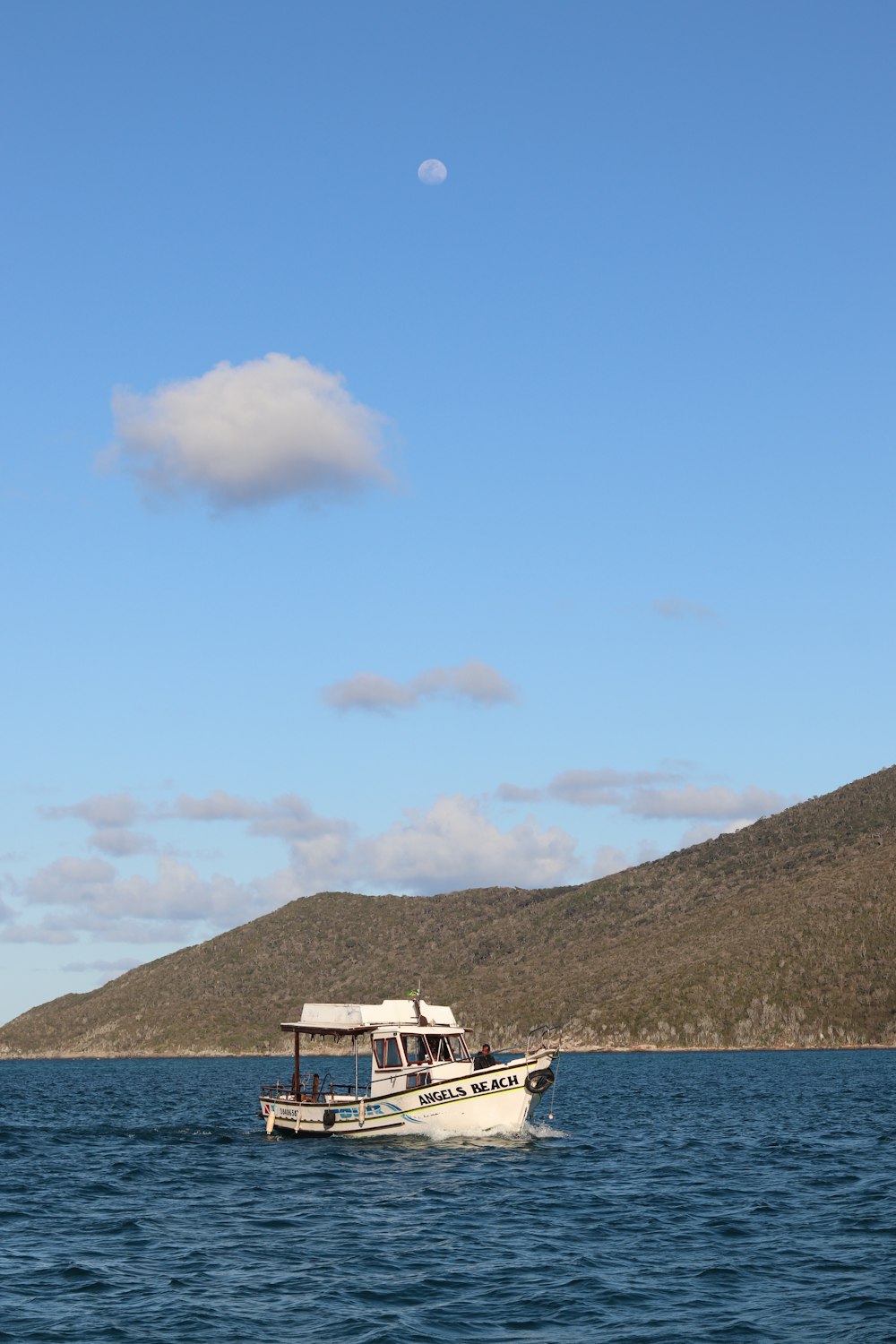 a white boat floating on top of a large body of water