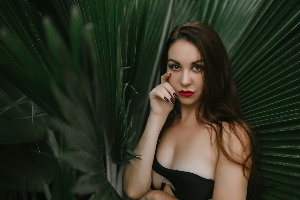 a woman in a black bikini posing for a picture