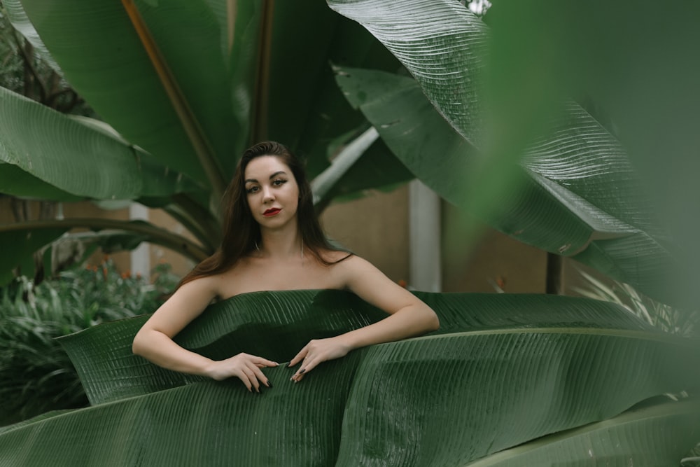 a woman in a green dress is posing for a picture