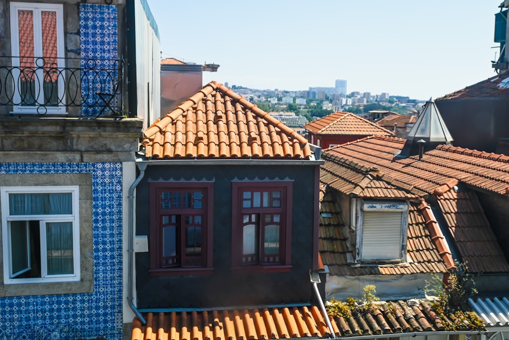 a group of buildings with tiled roofs and balconies