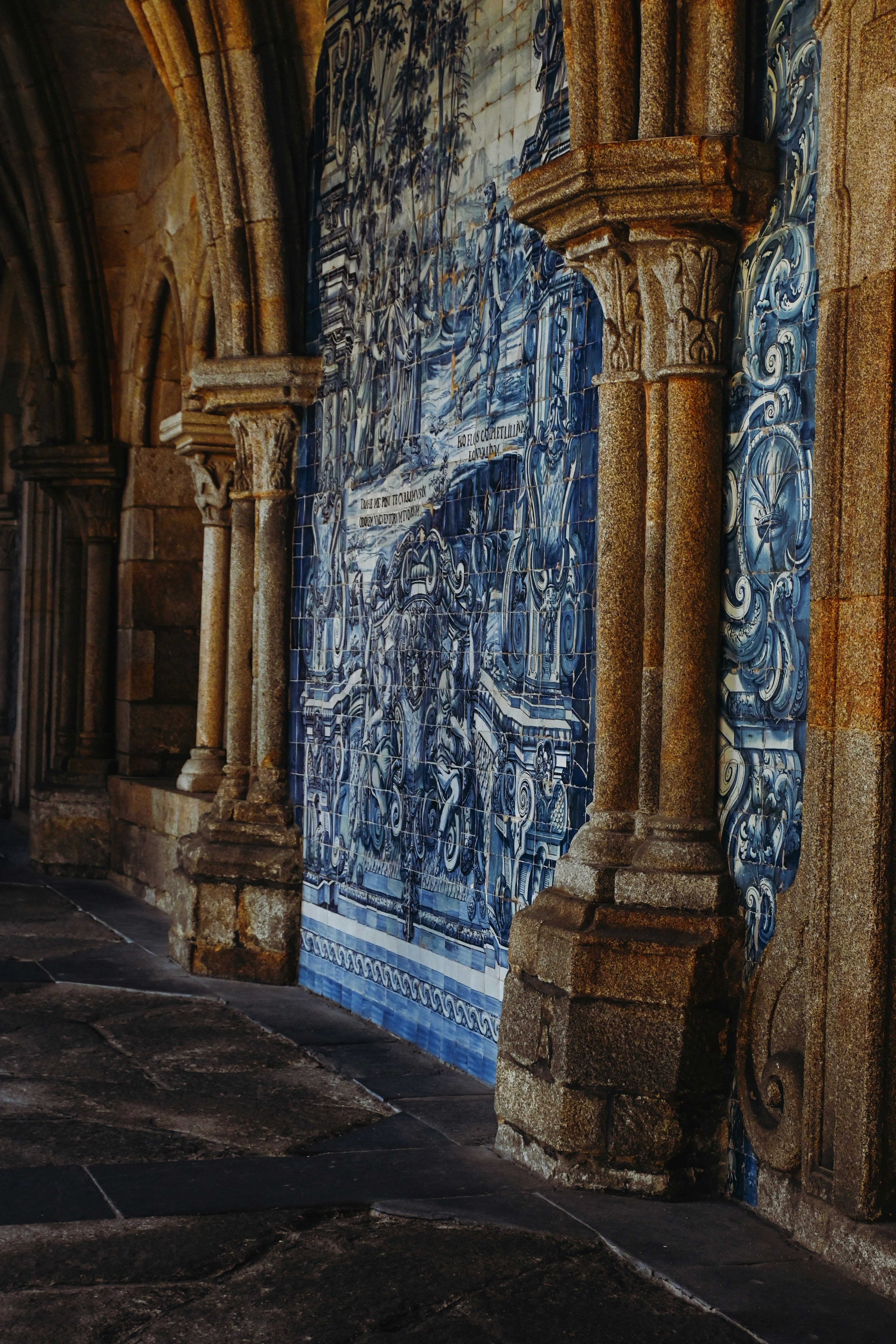 a blue and white tiled wall with columns