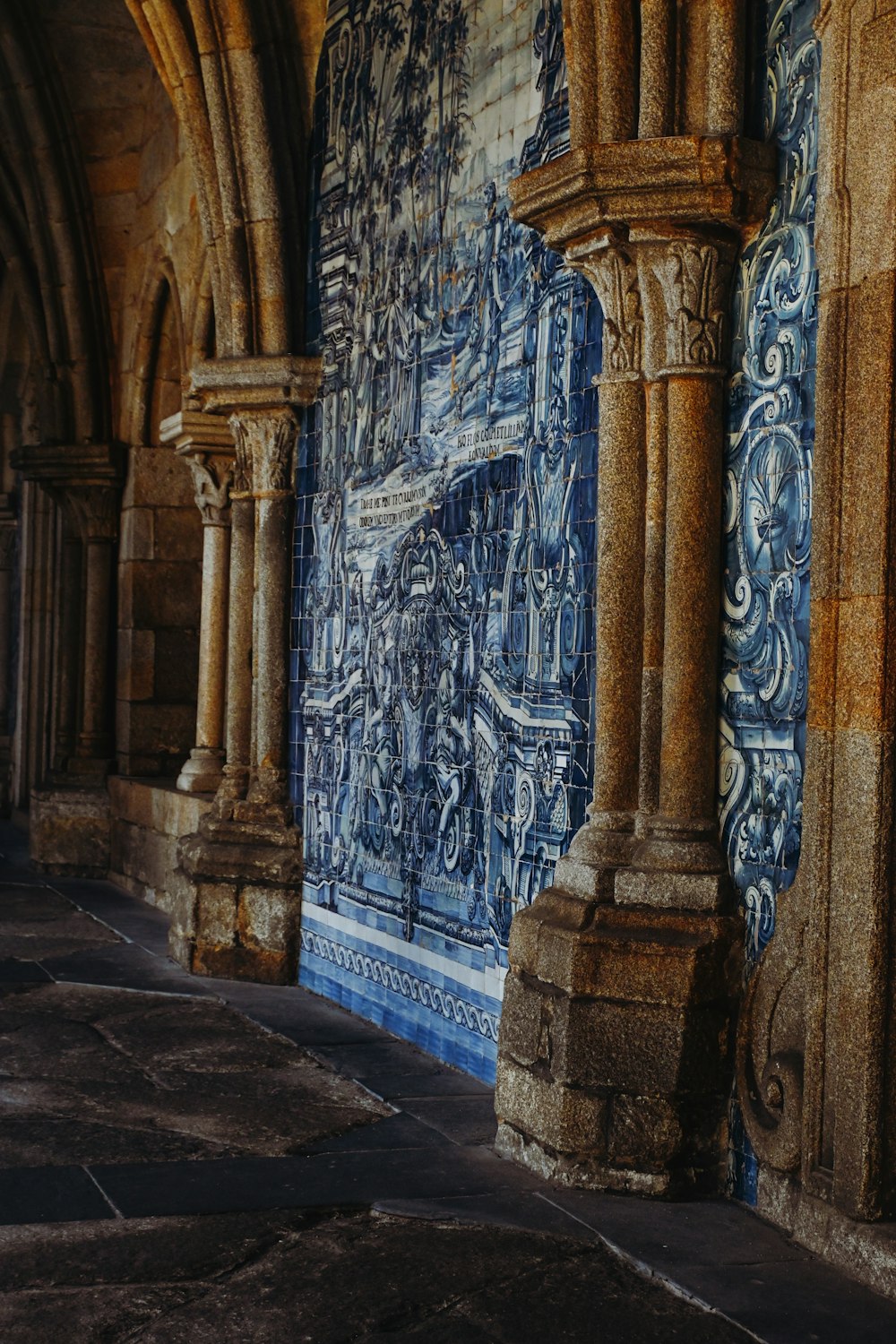 a blue and white tiled wall with columns