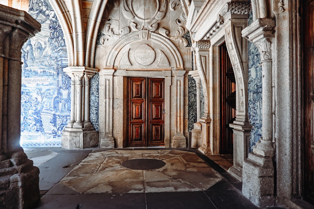 a room with a door and a wall with blue and white designs