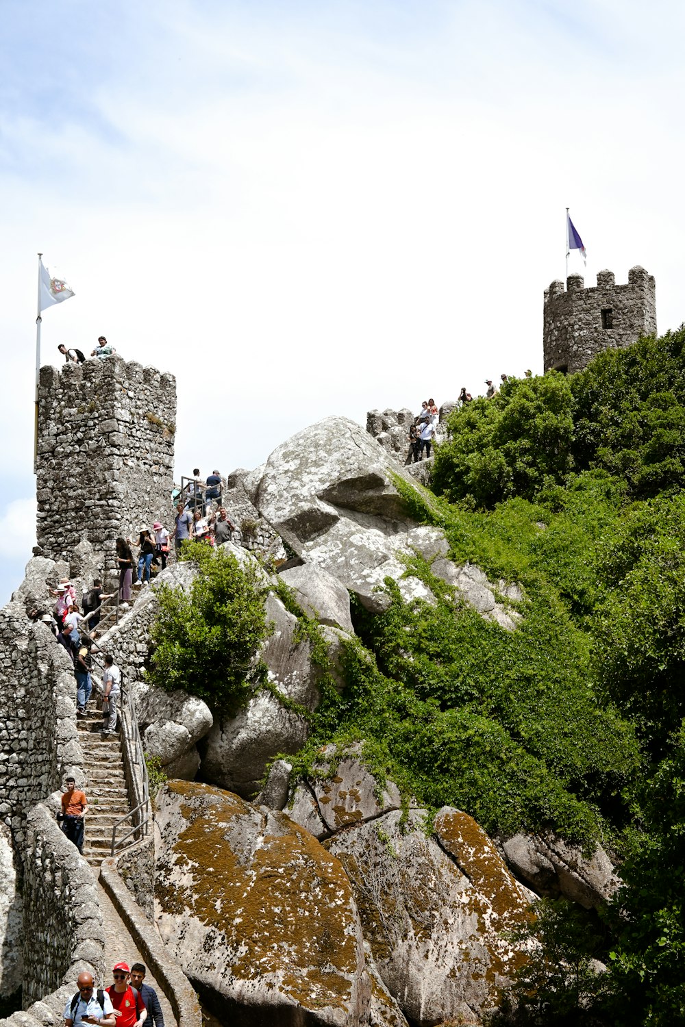 a group of people walking up a rocky hill