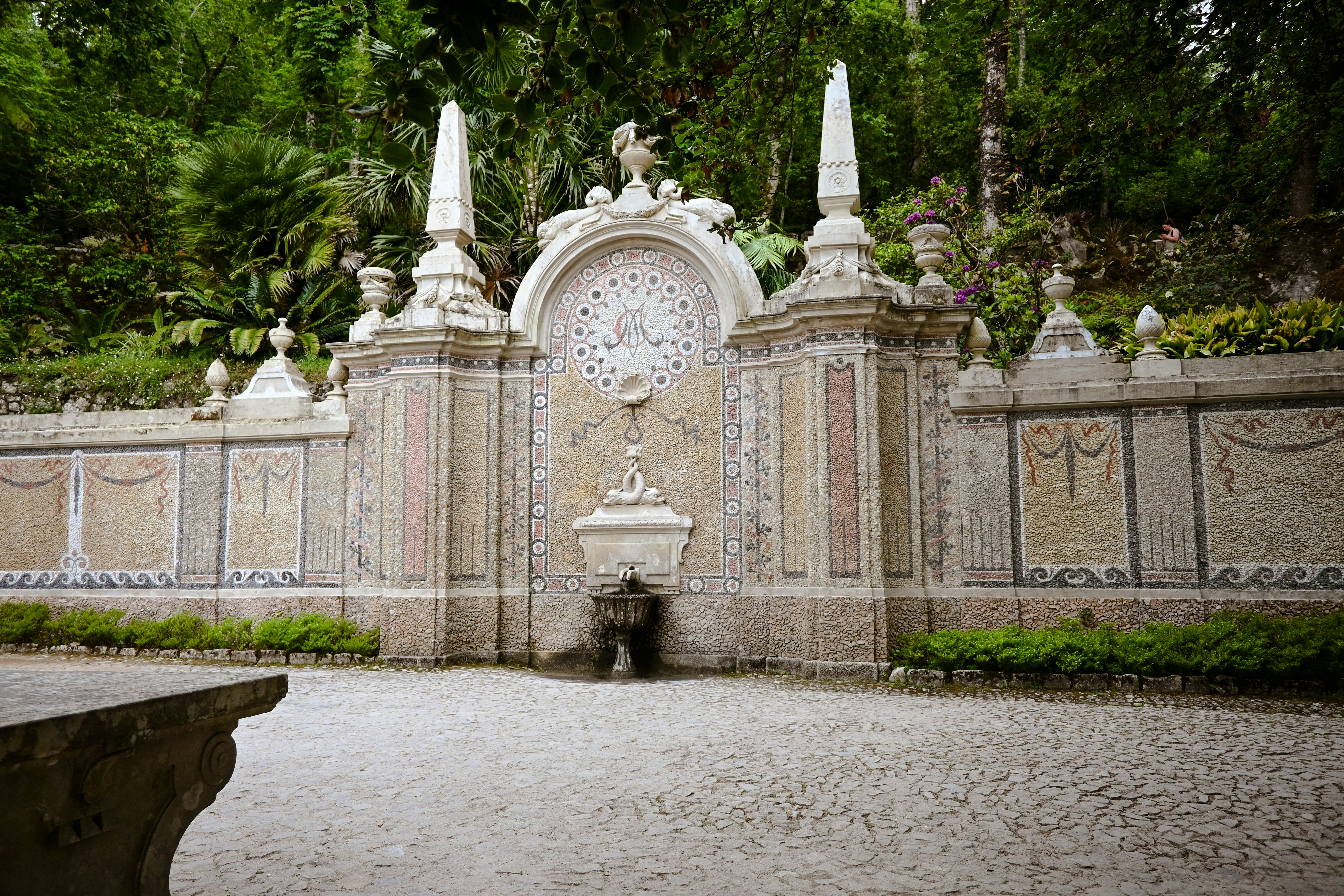 un cancello di pietra con un orologio in cima