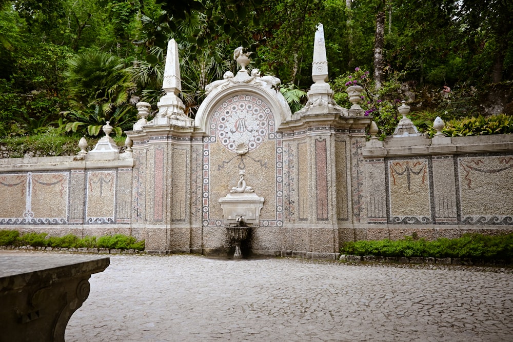 a stone gate with a clock on top of it