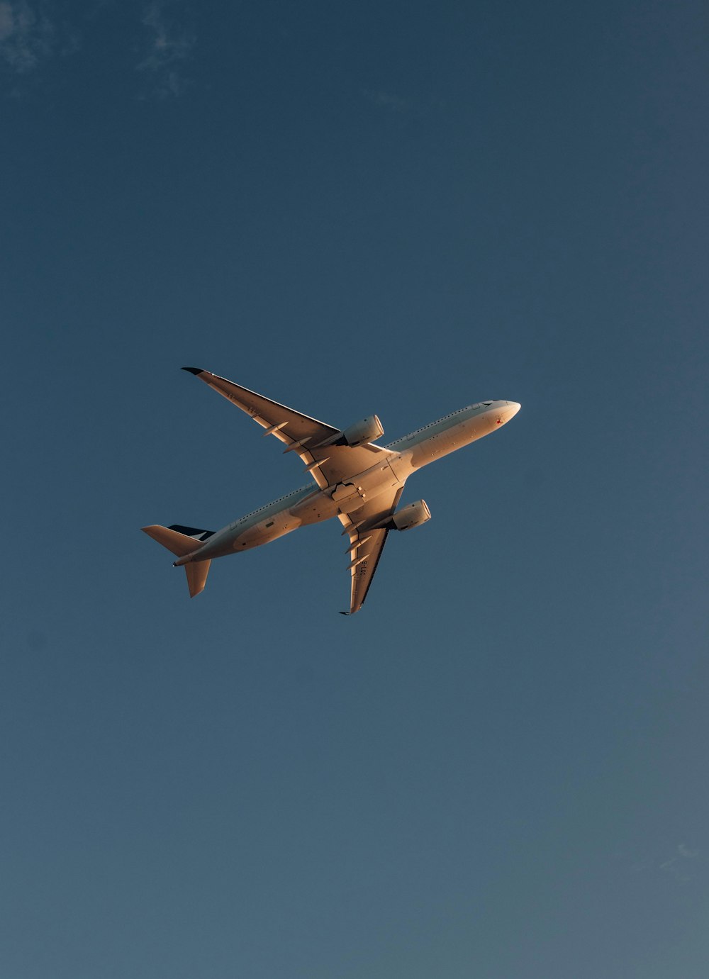 a large jetliner flying through a blue sky