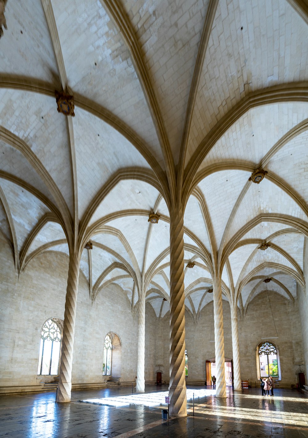 a large room with columns and a clock on the wall