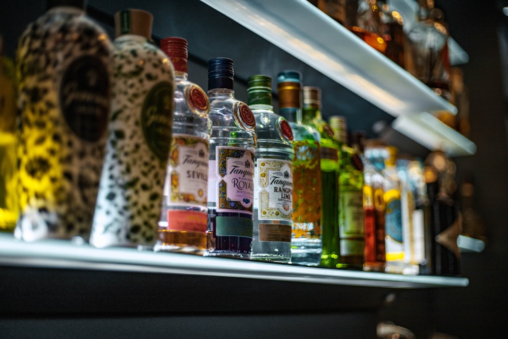 a row of liquor bottles sitting on top of a shelf