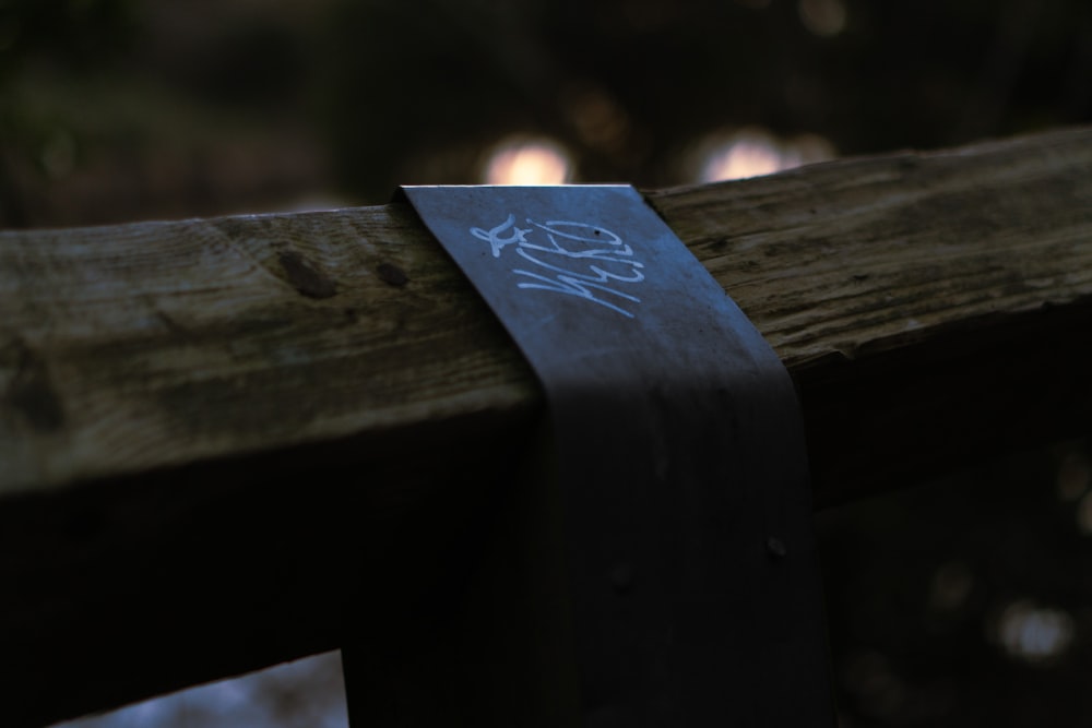 a piece of paper taped to a wooden rail