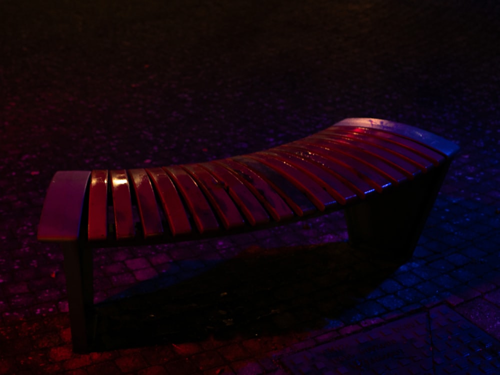 a wooden bench sitting on top of a sidewalk