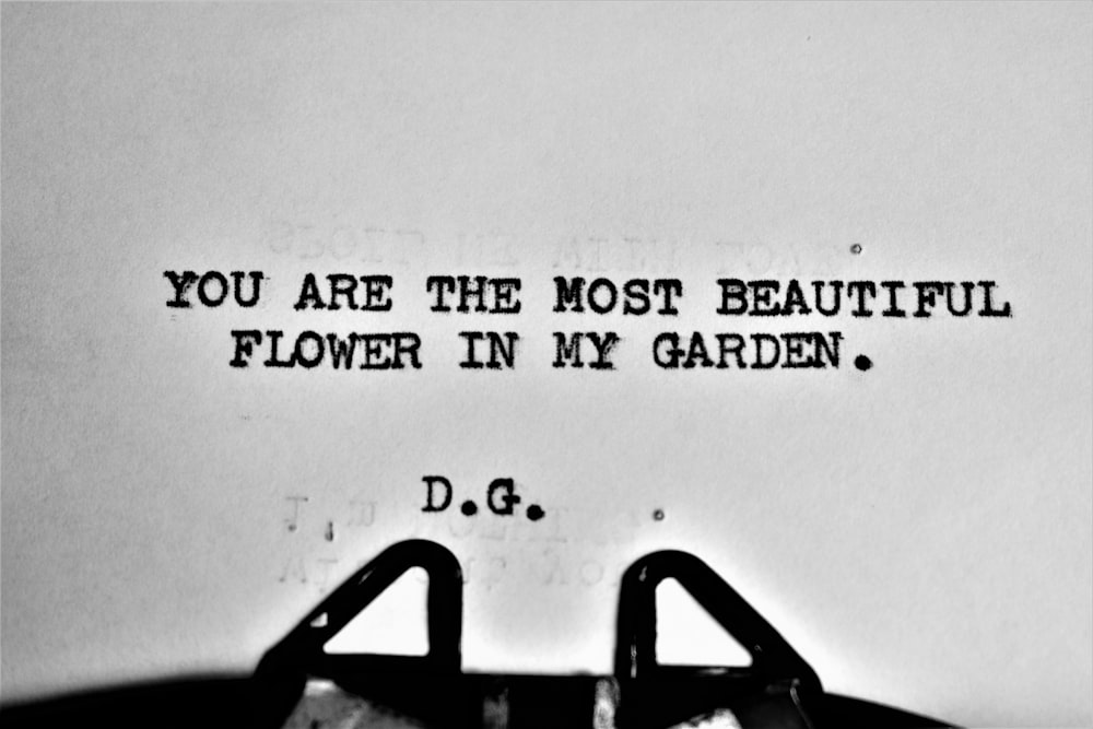 a typewriter with the words you are the most beautiful flower in my garden