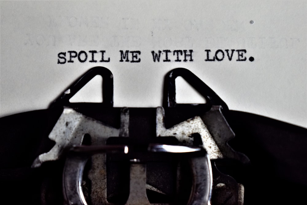 a typewriter with the words spoil me with love written on it