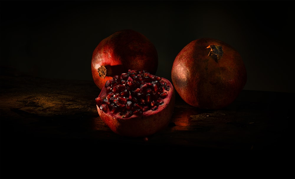 a couple of pomegranates sitting on top of a table