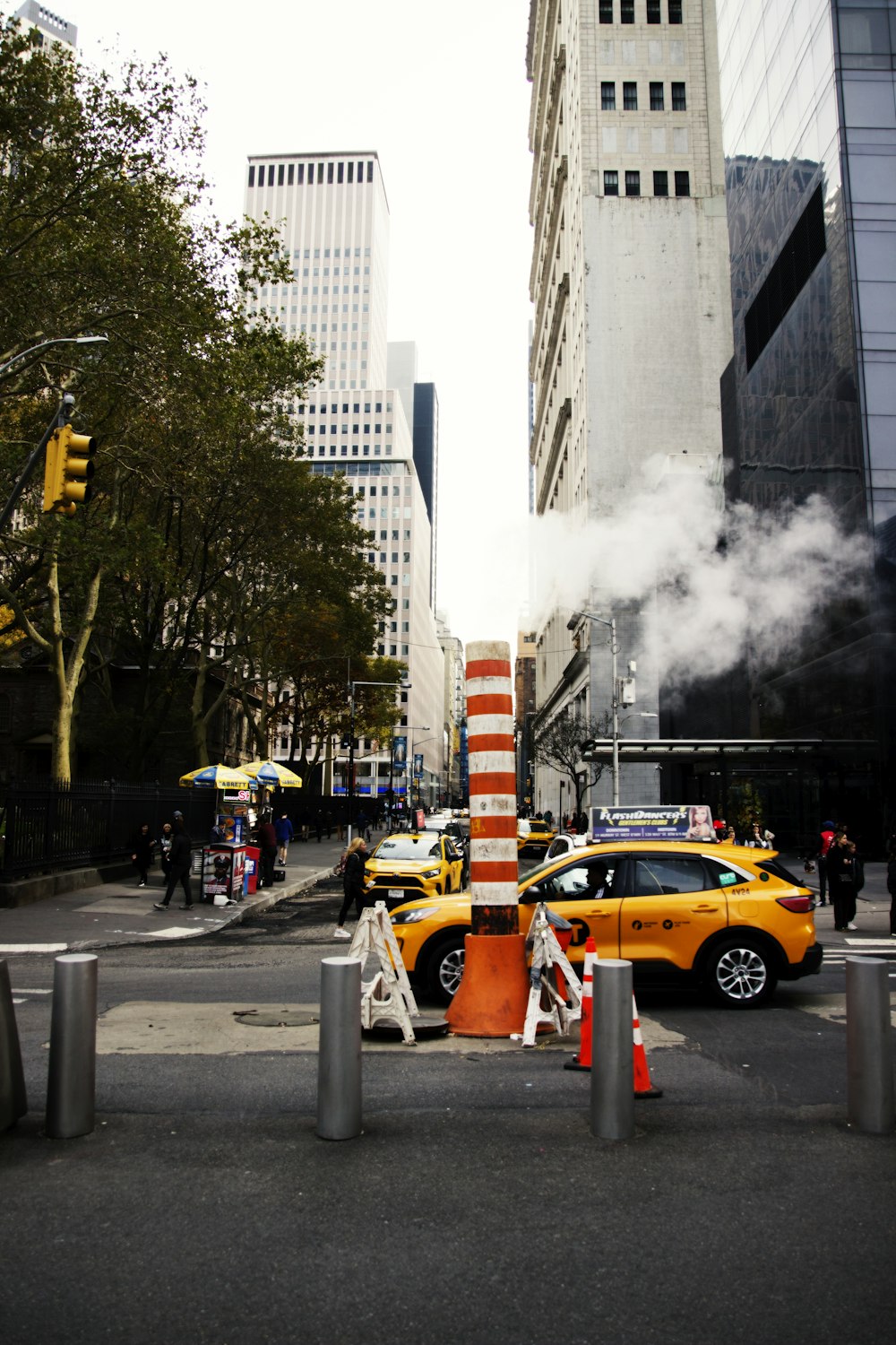 a yellow car is driving down the street